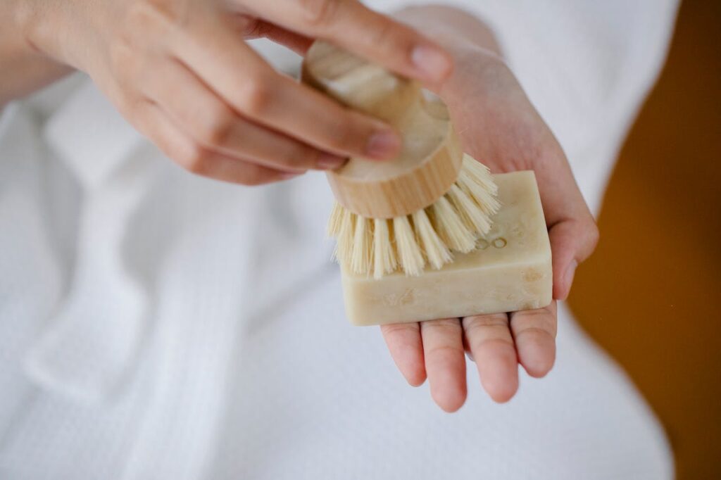 Crop woman with eco brush and soap bar